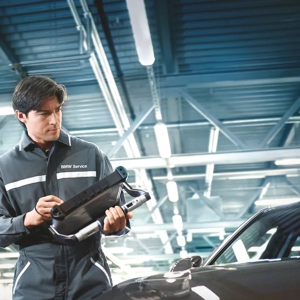 a service technician looking at a vehicle